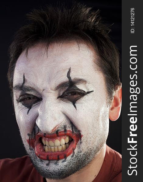 Clown looking at camera on a black background. Clown looking at camera on a black background