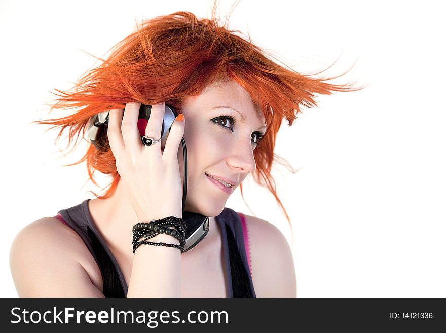 Redhead young woman holding headphones and dancing. Redhead young woman holding headphones and dancing