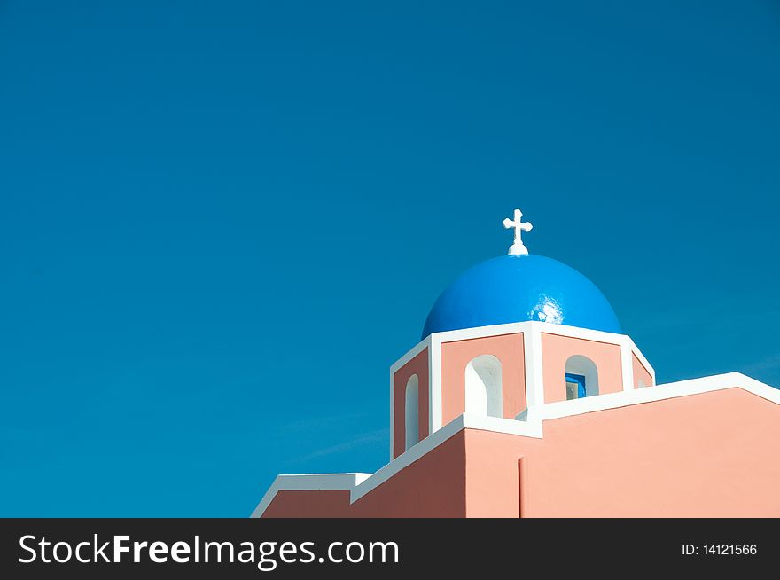 Greek church in santorini greece with a cross