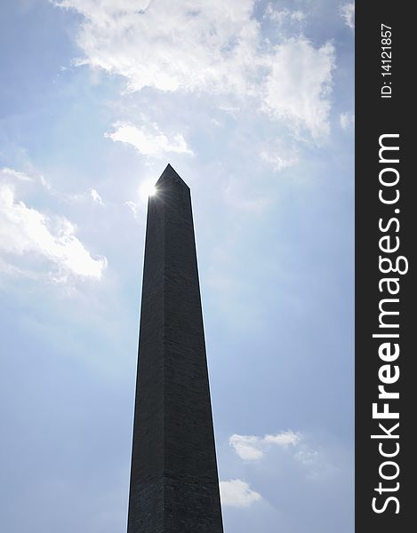 Washington monument in Washington DC against blue sky with flare