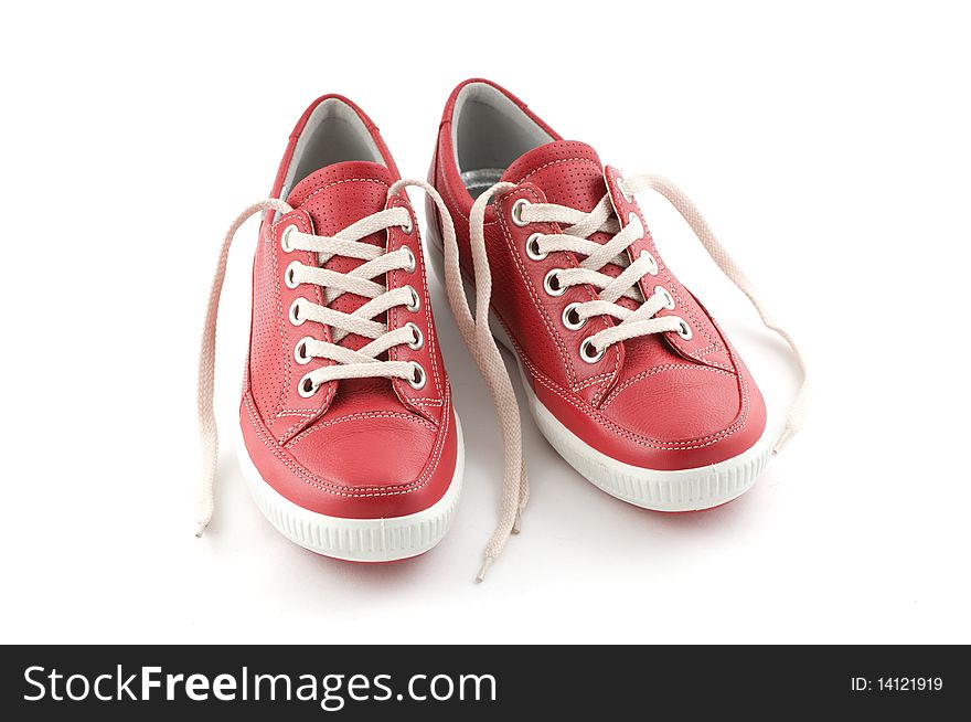 Red leather sneakers on white