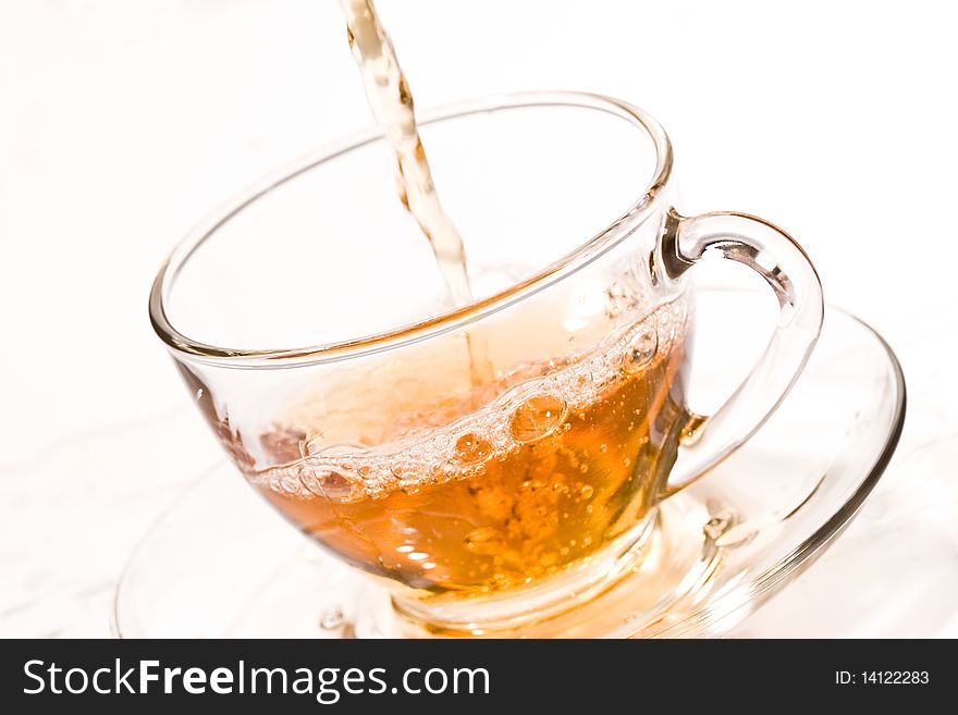Drink series: pouring tea into glassy tea cup