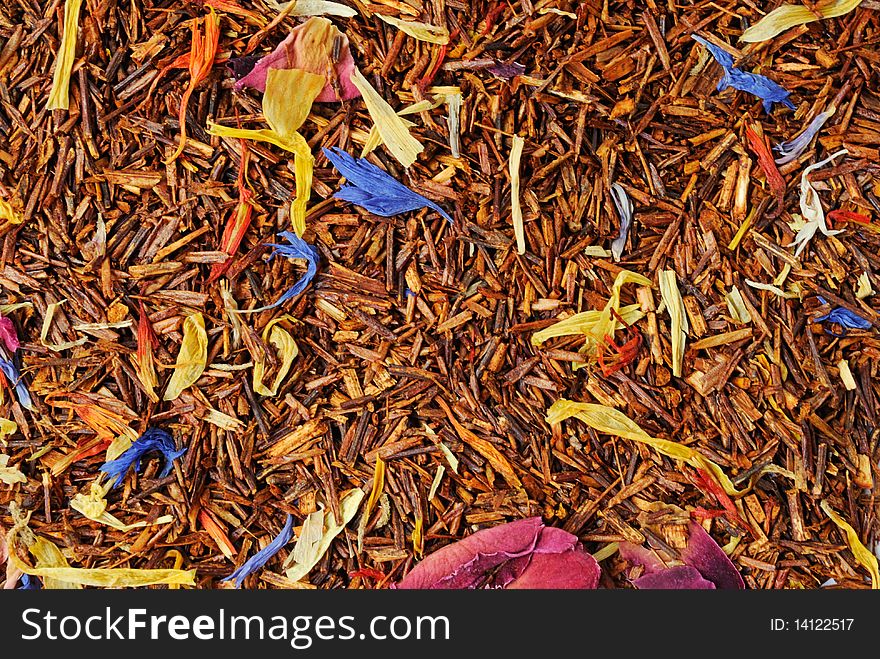 Roibush tea with a flowers mix closeup on white background