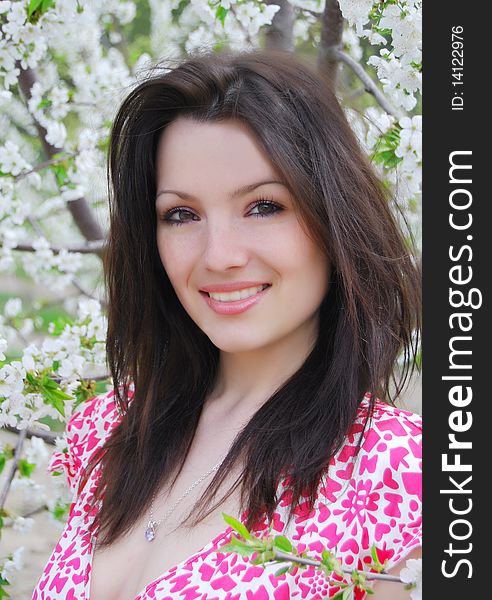 The beautiful girl in a garden on walk