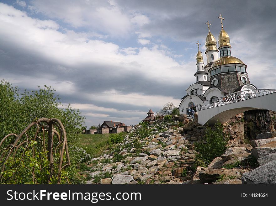 Gold-domed church under cloudy sky