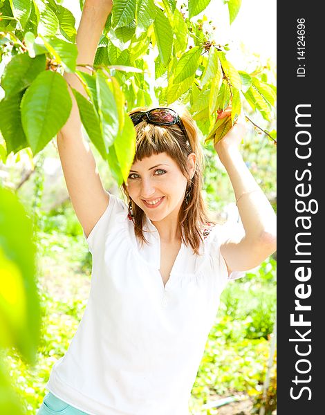 Beautiful young girl enjoying the sunny day in an orchard. Beautiful young girl enjoying the sunny day in an orchard