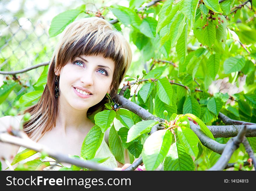 Beautiful young girl enjoying the sunny day in an orchard. Beautiful young girl enjoying the sunny day in an orchard