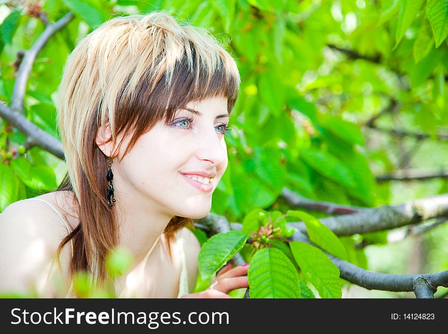 Beautiful young girl enjoying the sunny day in an orchard. Beautiful young girl enjoying the sunny day in an orchard