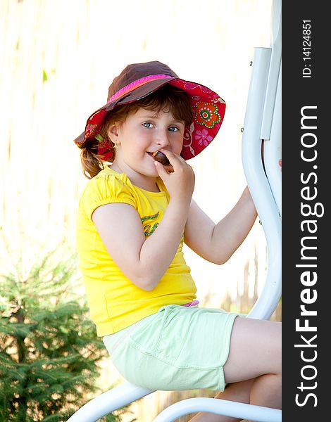 Portrait of a young girl eating a cookie. Portrait of a young girl eating a cookie