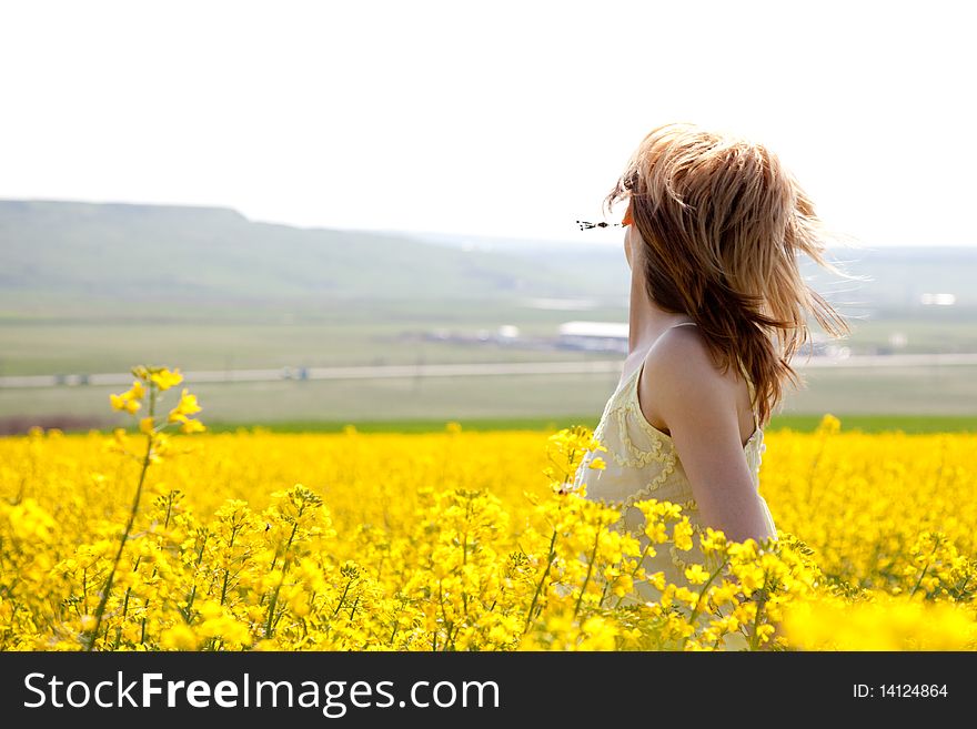 Beautiful young woman in a rapeseed field. Beautiful young woman in a rapeseed field