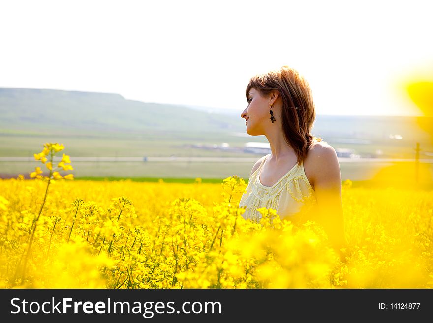 Beautiful young woman in a rapeseed field. Beautiful young woman in a rapeseed field