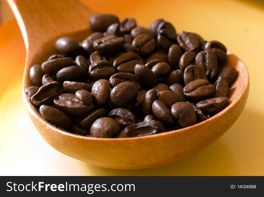 Fresh roasted,coffee beans in the spoon,close up