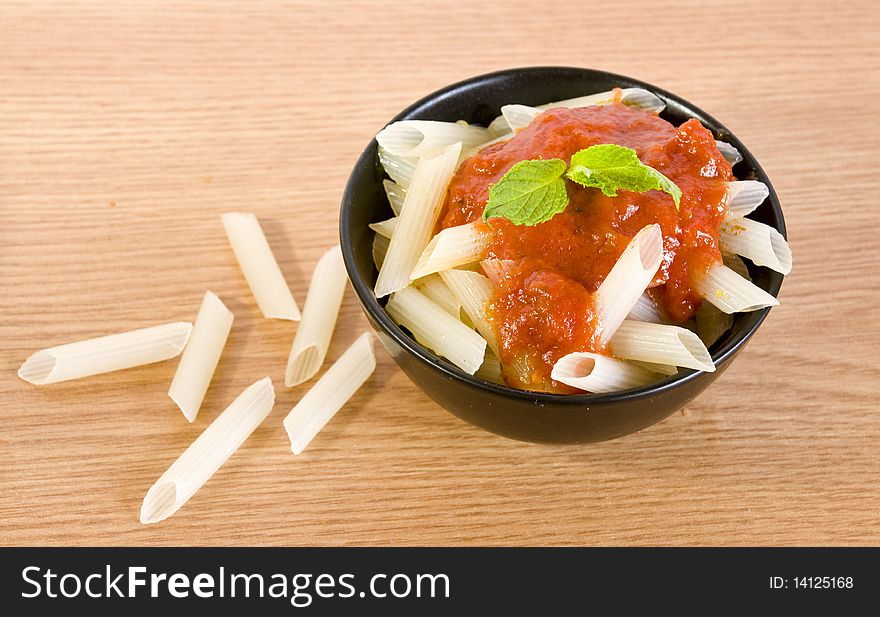 Freshly cooked rice penne with hot tomato sauce