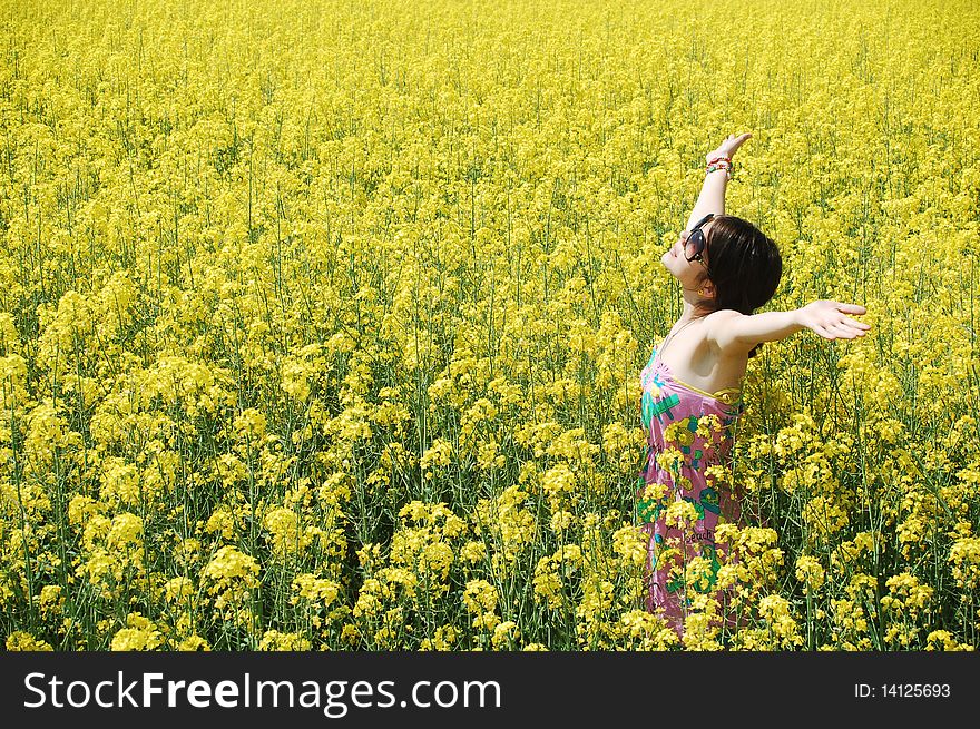 Young girl enjoying a sunny day on canola field. Young girl enjoying a sunny day on canola field