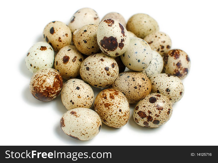 A pile of fresh quail eggs was shot is white background