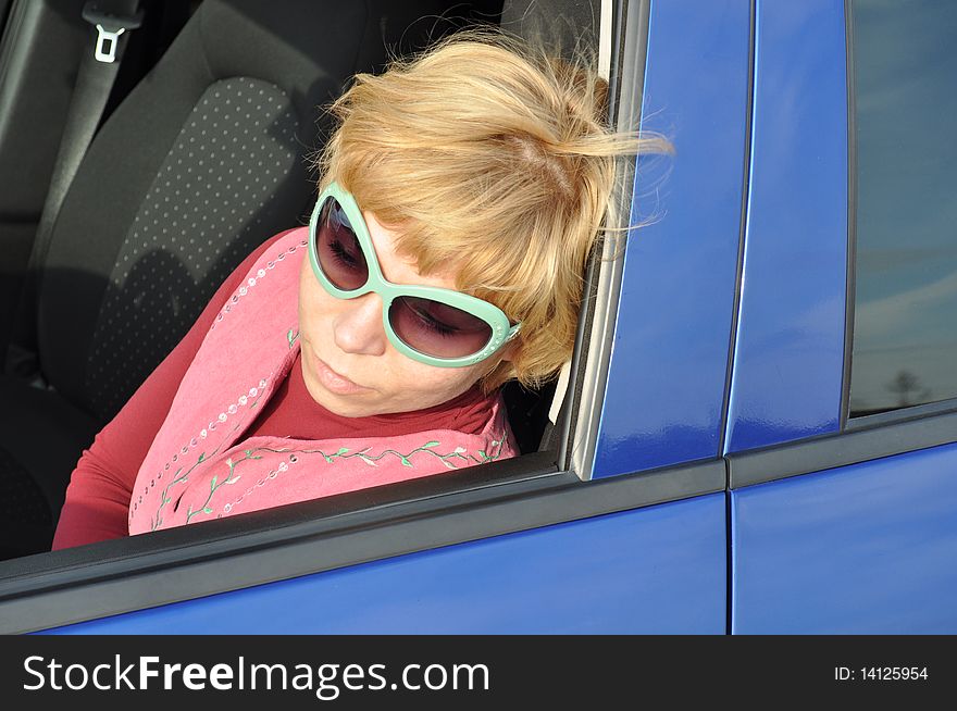 Young woman with blond hair looks out of the car, it is in green, wearing sunglasses and a pink dress.

You can find more pictures from this series here:
http://www.dreamstime.com/lightbox_det.php?id=588983
. Young woman with blond hair looks out of the car, it is in green, wearing sunglasses and a pink dress.

You can find more pictures from this series here:
http://www.dreamstime.com/lightbox_det.php?id=588983