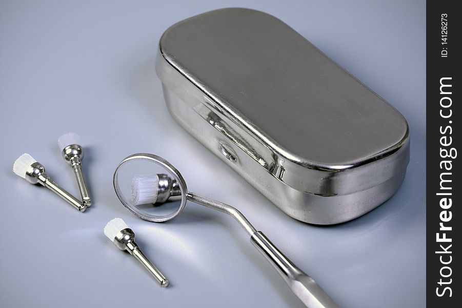 Close-up dental accessory brushs mirror and box. Close-up dental accessory brushs mirror and box