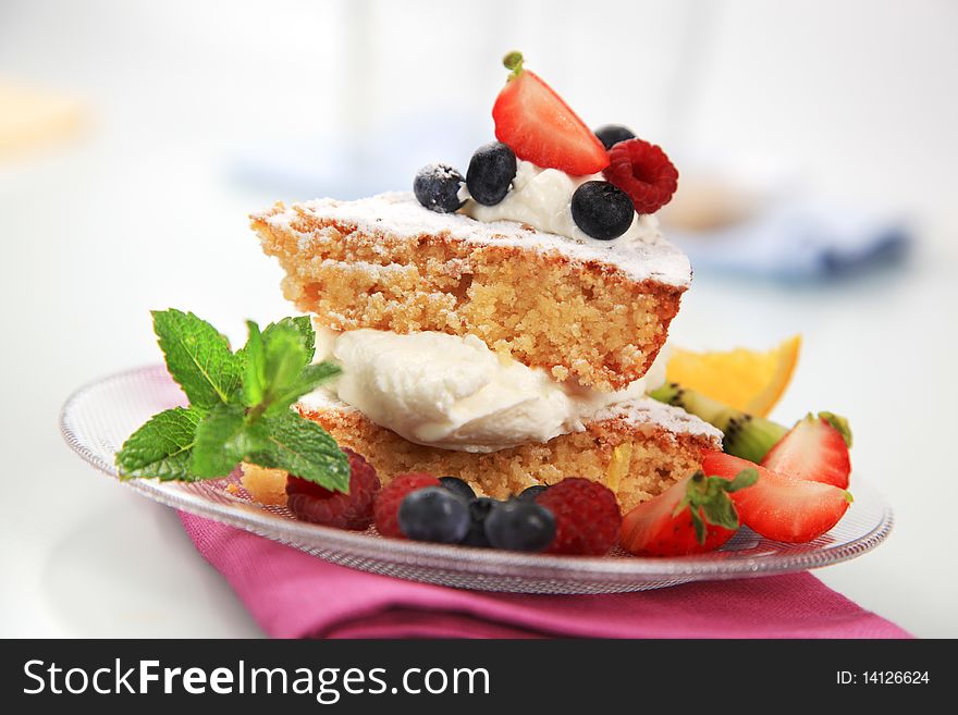 Slices of sponge cake with cream and fruit. Slices of sponge cake with cream and fruit