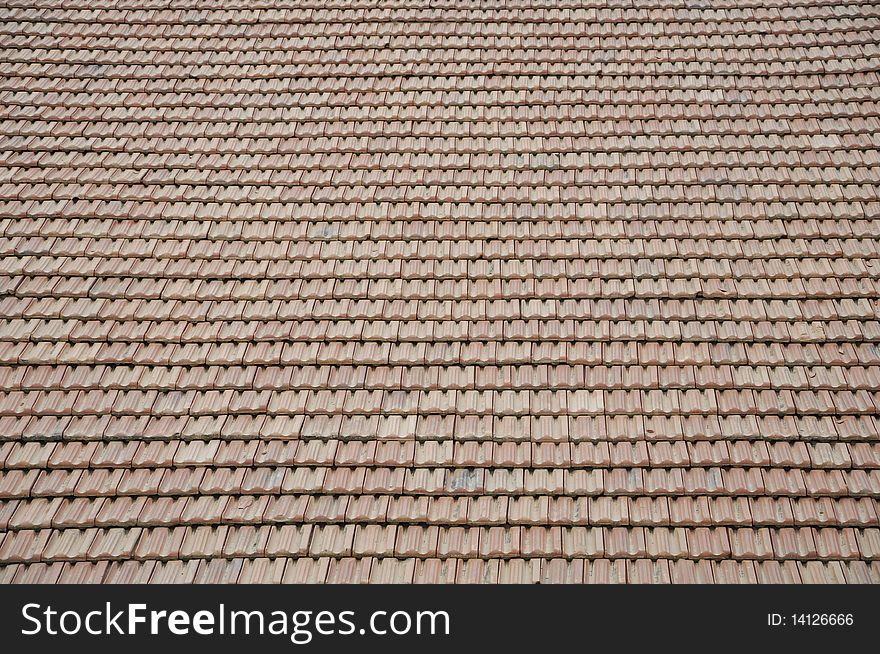 Worn tile roof on a sunny day