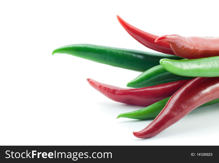Green and red chili peppers on white background