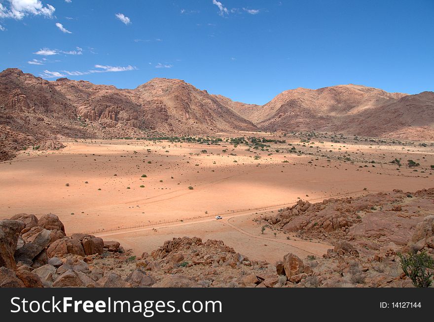 Namibrand mountains at Namib desert against a blue sky background, Namibia. Namibrand mountains at Namib desert against a blue sky background, Namibia.