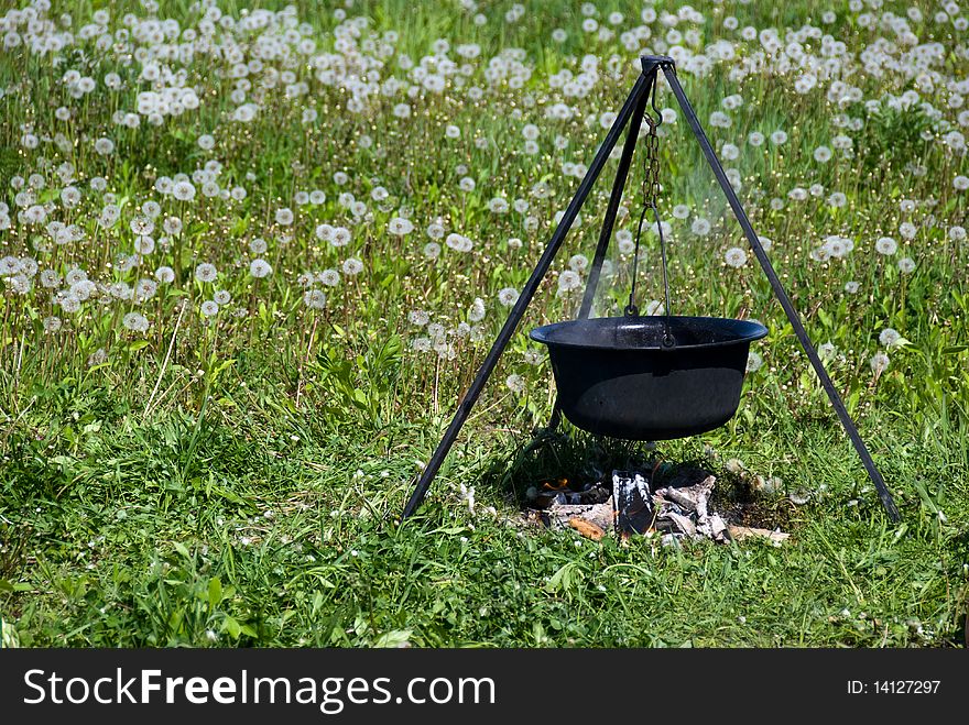 Tourist cauldron	boiling on a fire. Tourist cauldron	boiling on a fire