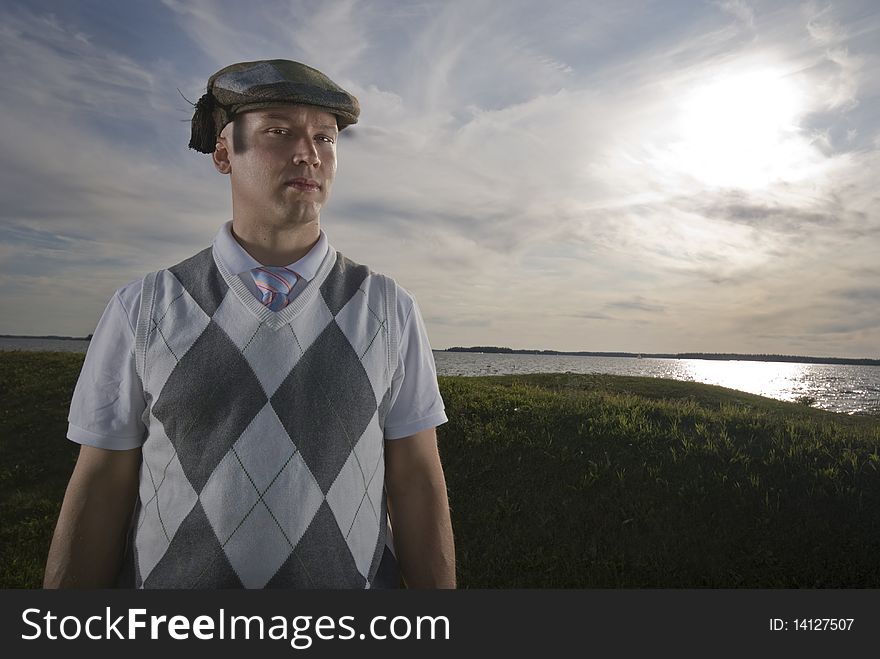 Outdoors portrait of an handsome man wearing a funny hat. Outdoors portrait of an handsome man wearing a funny hat.