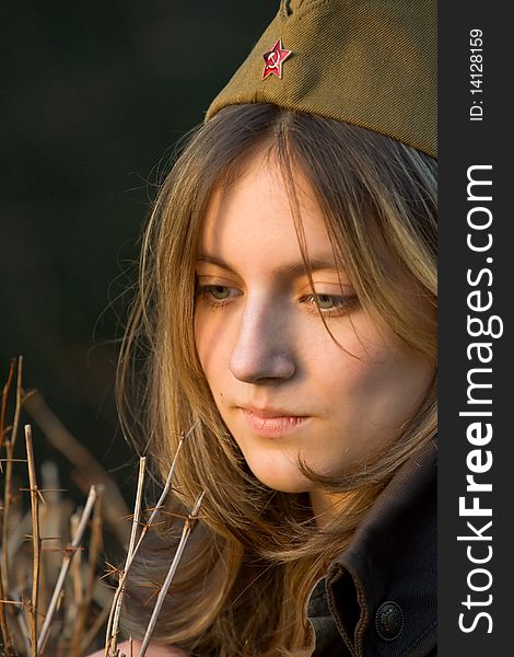 Photo of a young woman in military cap. Photo of a young woman in military cap