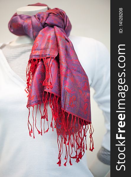 Foulard with red tones on a mannequin