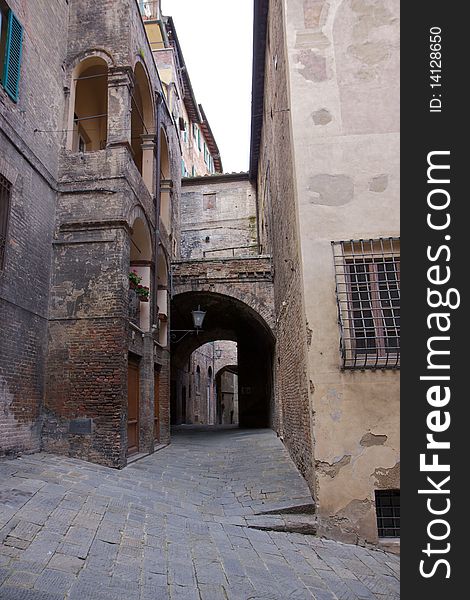 A narrow, steep street in the Tuscan city of Siena. A narrow, steep street in the Tuscan city of Siena