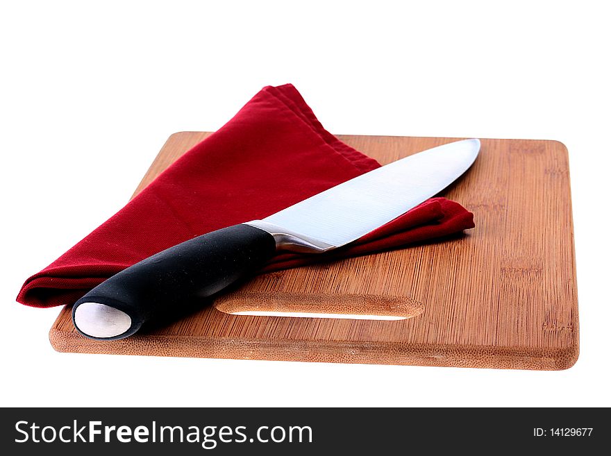 Professional big cook knife on darkly red napkin and a kitchen board.