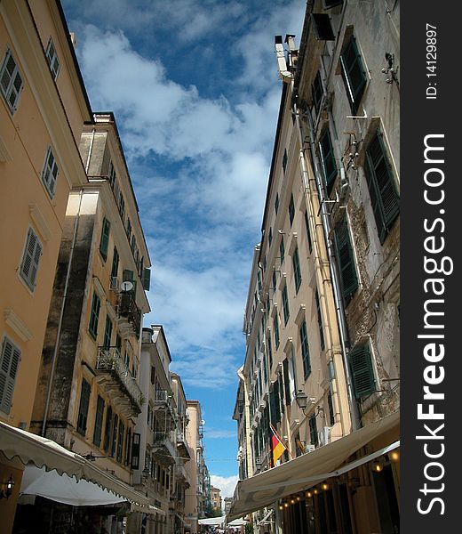 Perspective shot of street in Corfu Greece. Beautiful sky and clouds are present. Perspective shot of street in Corfu Greece. Beautiful sky and clouds are present.