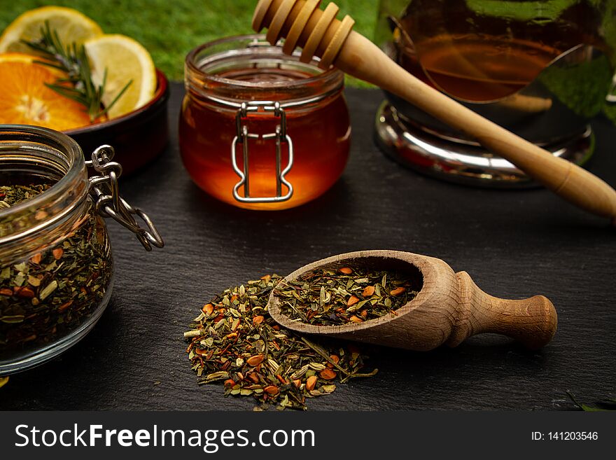 Close up of herbal tea and honey over black background