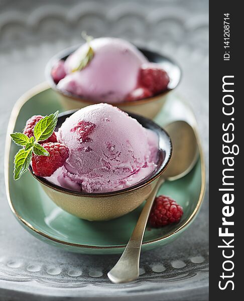 Homemade organic ice cream scoops with berries and raspberry. Homemade organic ice cream scoops with berries and raspberry