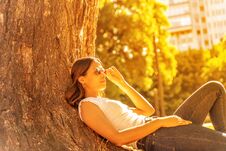 Free A Young Woman Lying Next To A Tree And Enjoying The Sunshine Royalty Free Stock Photo - 141210395