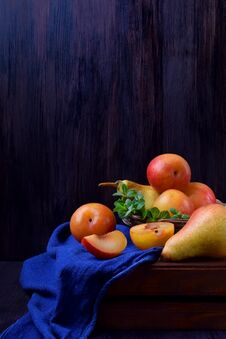 Red And Yellow Plums, Pears And Mint On A Wooden Table Stock Photos