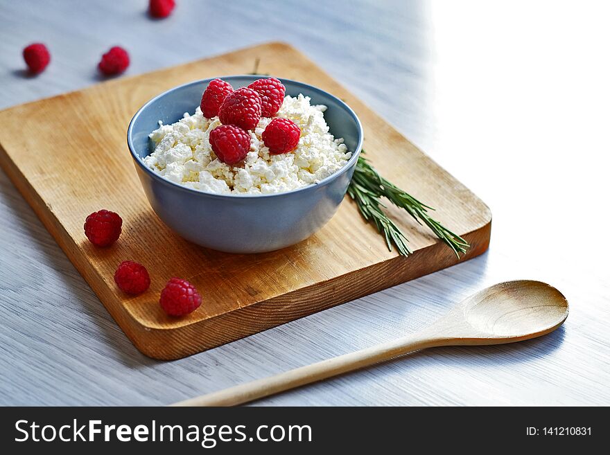 Cottage cheese with fresh raspberries in a bowl, healthy breakfast