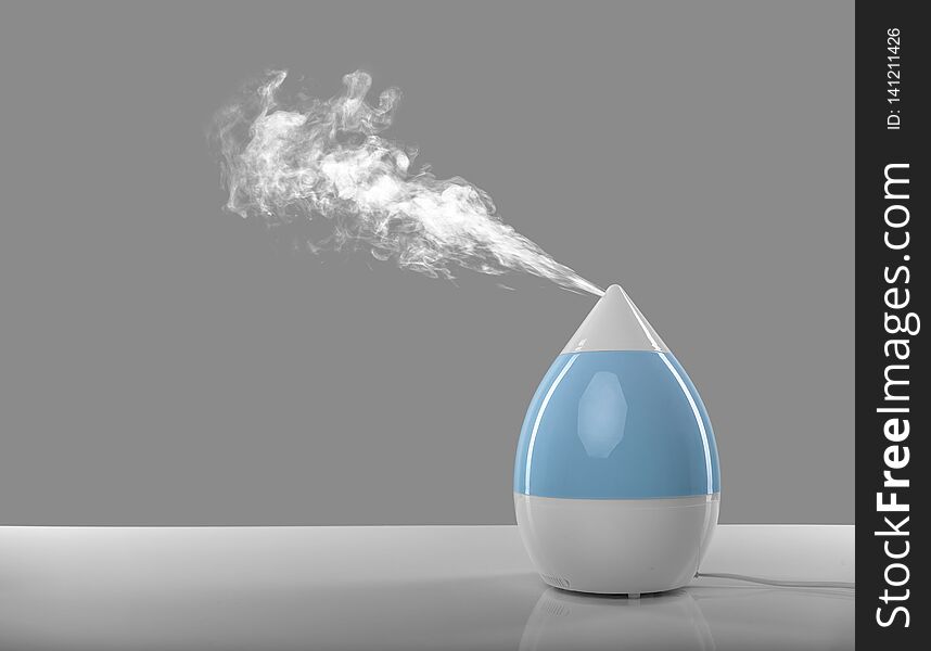 White-blue air humidifier. The unique design quickly and effectively eliminates dry air, providing an optimal level of humidity in the room.