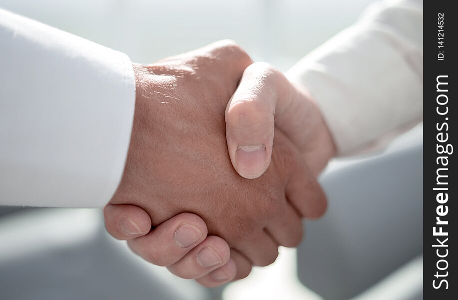 Close up.reliable handshake of business partners .the concept of cooperation