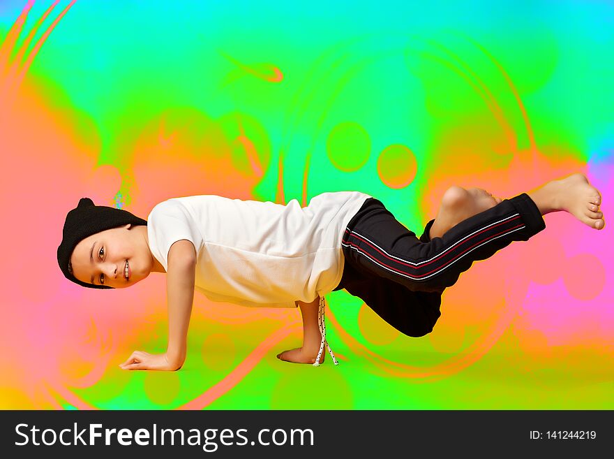 Young man break dancing on colorful background