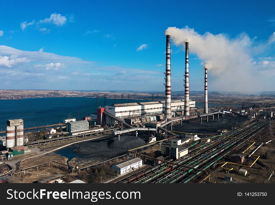 Old thermoelectric plant with big chimneys in a rural landscape. Burshtyn, Ukraine
