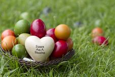 A Basket Of Easter Eggs Sitting In The Grass Stock Photos
