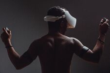 Backside Of African Male Muscular Athlet With Naked Torso Using Vr Headset Stock Image