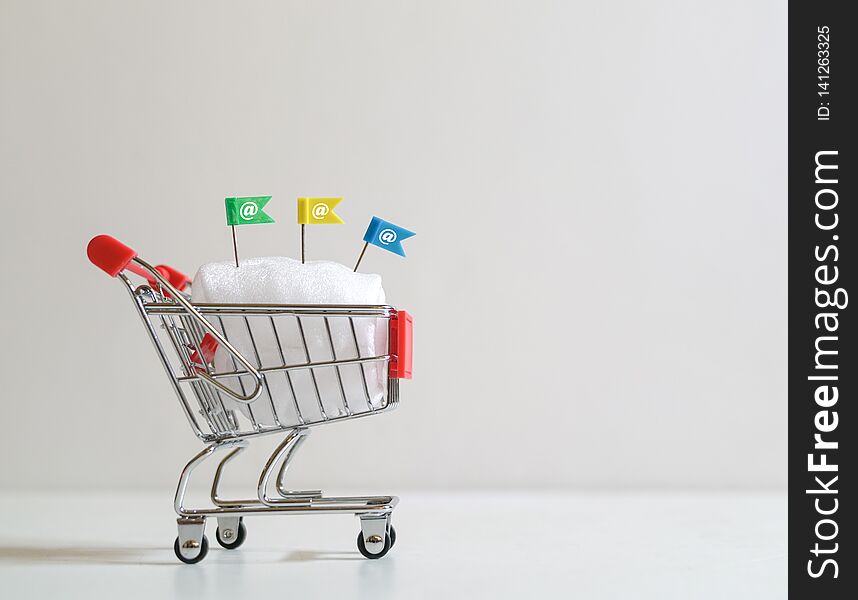 Online shopping concept : Shopping cart or trolley carrying the e-mail symbol. Online shopping concept : Shopping cart or trolley carrying the e-mail symbol