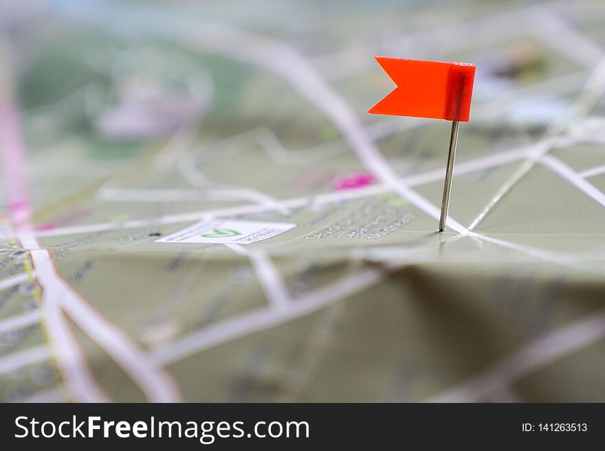 Travel concept: a red flag pin on a landmark of a map. Travel concept: a red flag pin on a landmark of a map