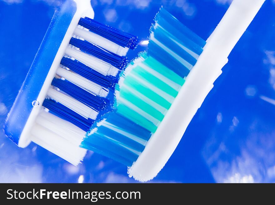Toothbrush closeup closeup on a blue background the concept of oral hygiene. Toothbrush closeup closeup on a blue background the concept of oral hygiene