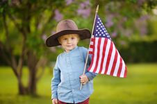 Free Cute Toddler Boy Holding American Flag In Beautiful Park Stock Photos - 141275843