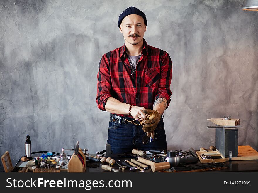 Attractive Man Is Standing At The Table And Looking At The Camera