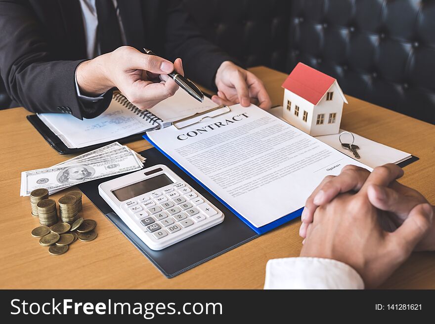 Estate agent broker giving pen to client signing agreement contract real estate with approved mortgage application form, buying or concerning mortgage loan offer for and house insurance