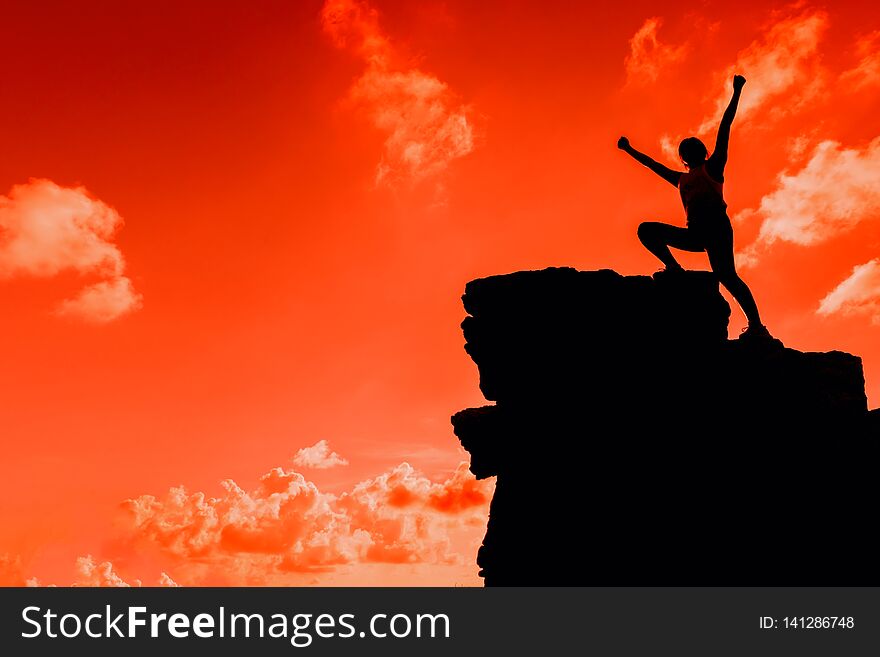 Silhouette Sporty woman climbing on the cliff. Success and goal concept. Strong and healthy for outdoor activity